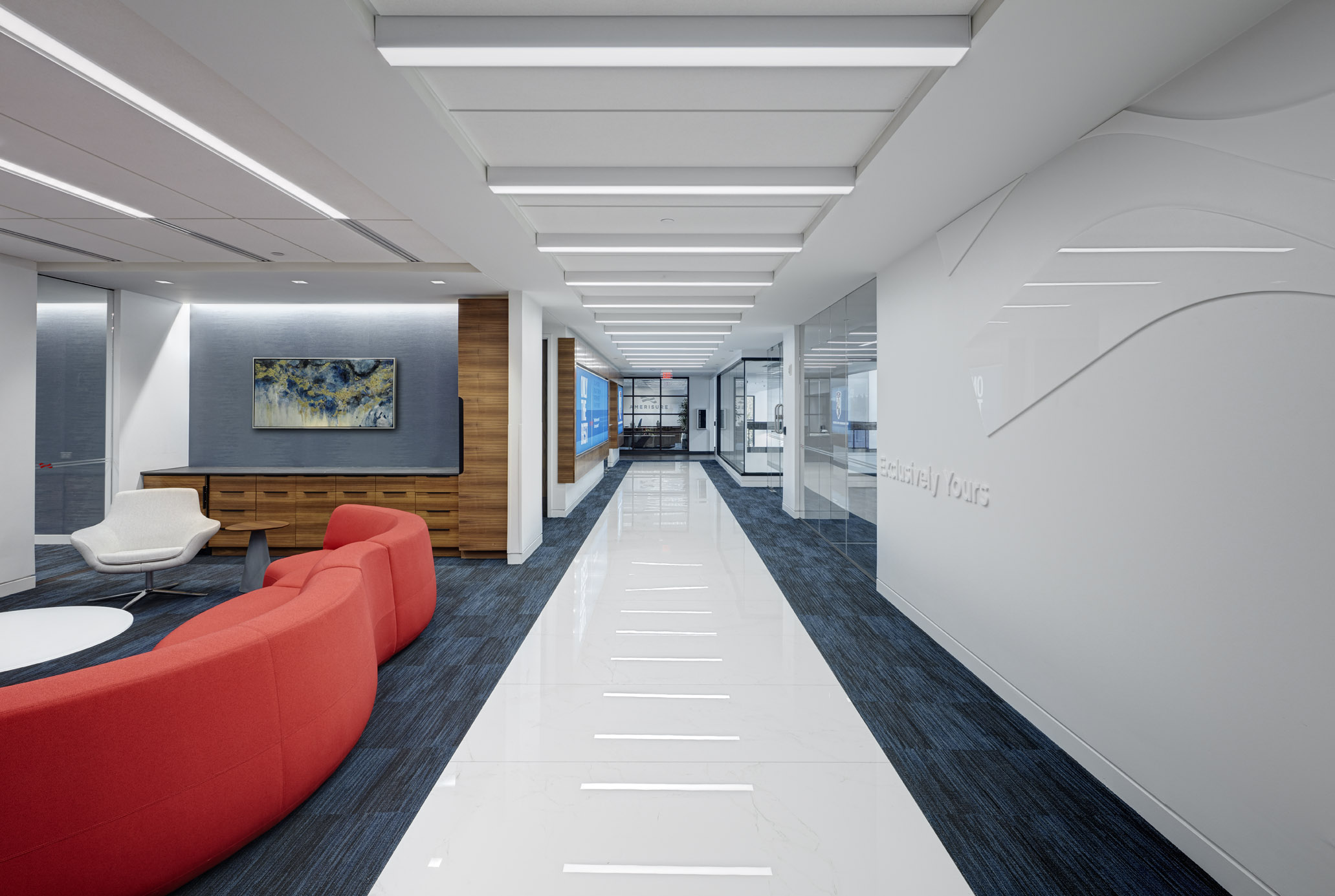 A photo of a hallway with white floors and red furniture